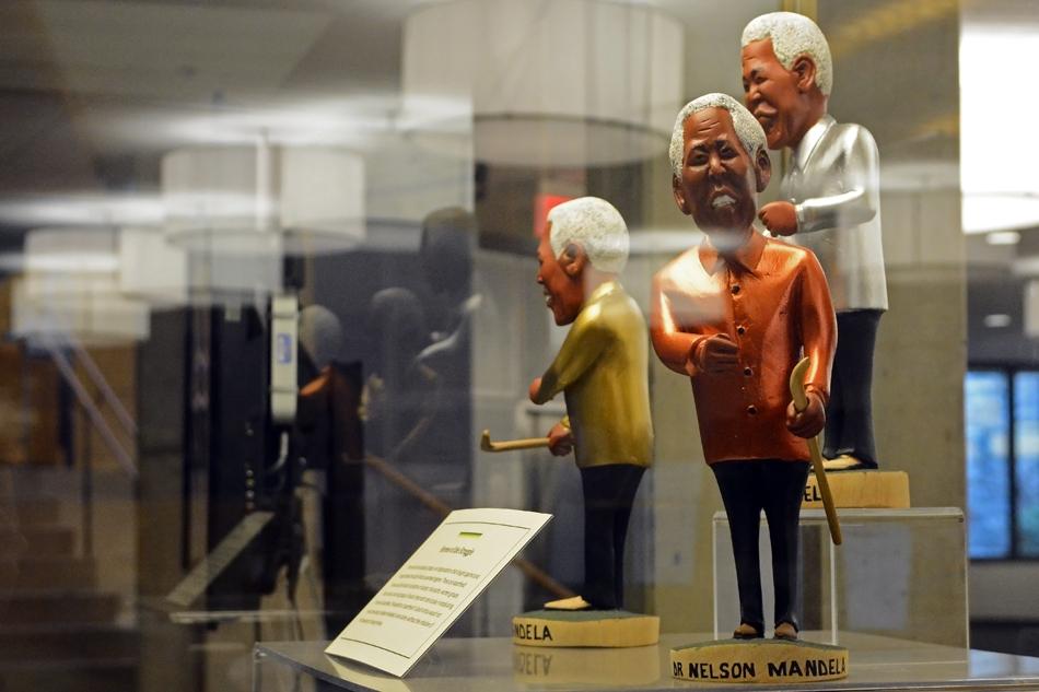 Figurines depicting Nelson Mandela are shown on display in University Library. April 27 marked the 20th anniversary of Mandela’s election as South Africa’s first black president.