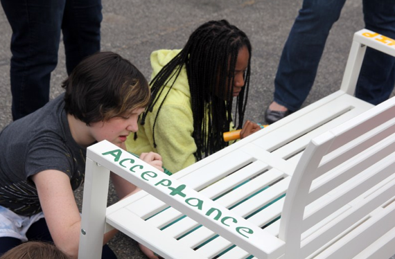 D65 students paint a “buddy bench” that will be installed at their elementary school in an effort to fight bullying. The project comes from Caring Outreach by Parents in Evanston, a volunteer group that aims to provide for community families in need.