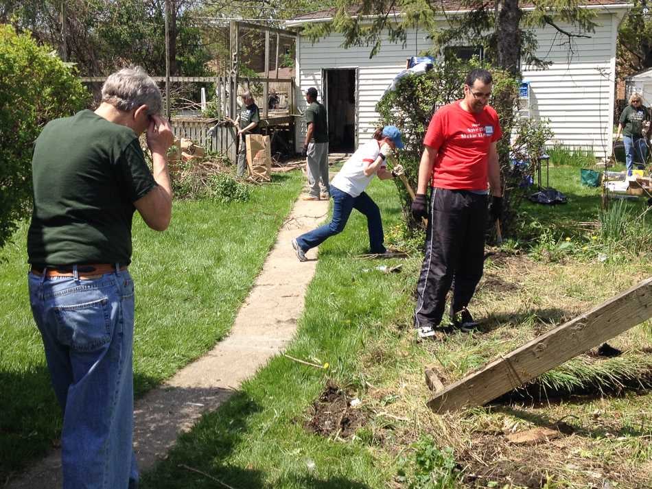 Volunteers with CPAH demolish the backyard of a foreclosed and vacant house on Hartrey Avenue.