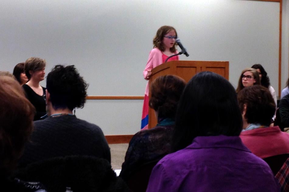 Ten-year-old Rachel Gelhausen reads her poem From a Cats Eyes to an audience at the Evanston Public Library. Gelhausen is one of many children and adults who read their work at the event.