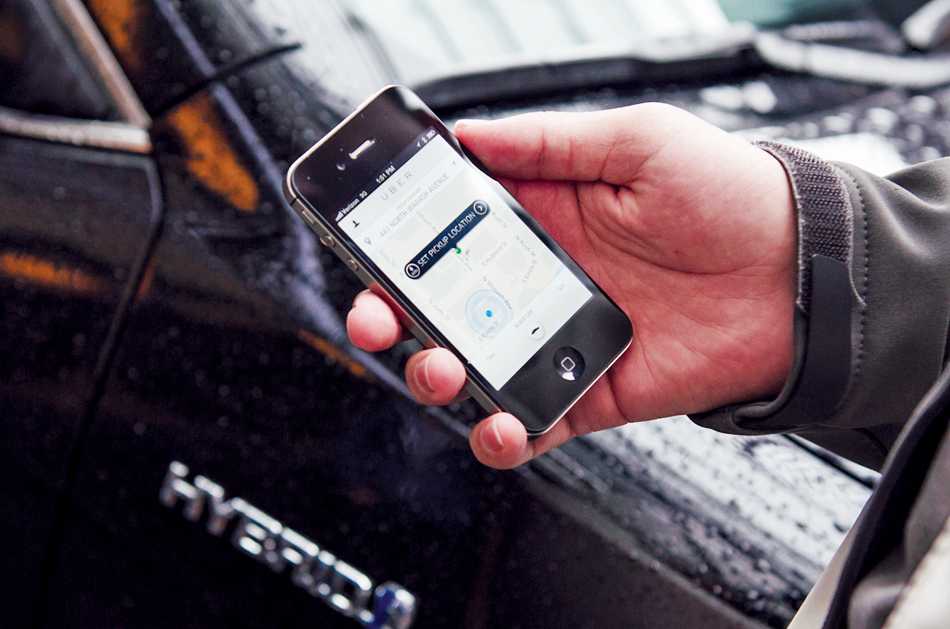 Ridesharing service Uber connects users with drivers through a smartphone app. Uber and other rideshare companies have expressed opposition toward a state bill that would impose new regulations on their operations.