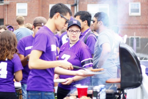 Students congregate by the grill at Fitzerland, the student tailgate area, before the 2013 football game against Maine.