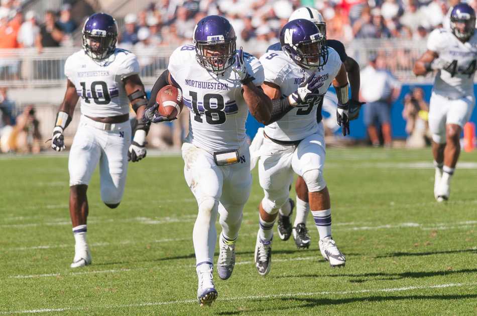 Redshirt freshman linebacker Anthony Walker dashes to the end zone with a game-sealing interception return in Northwestern's 29-6 victory over Penn State on Saturday. Making his first career start, Walker led the team with eight tackles, in addition to the pivotal pick-six.