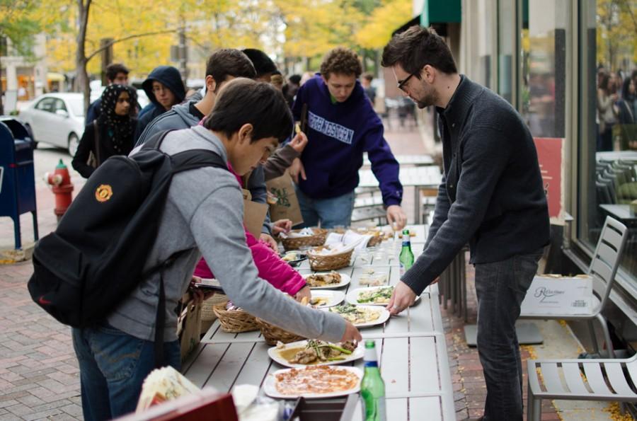 Students sample free food from Evanston restaurants at Associated Student Government’s annual Big Bite Night. The event drew about 1,800 participants, and restaurant owners said they benefited from the exposure.