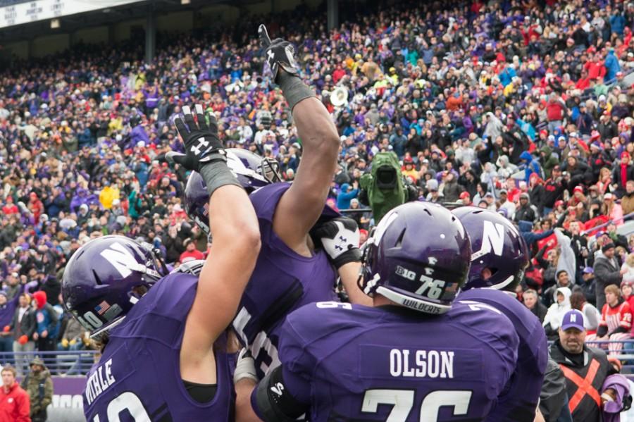 Junior+running+back+Miles+Shuler+celebrates+with+teammates+after+his+16-yard+run+on+a+third-quarter+reverse+play.+The+play+was+one+of+several+aggressive+calls+from+coach+Pat+Fitzgerald+and+offensive+coordinator+Mick+McCall.