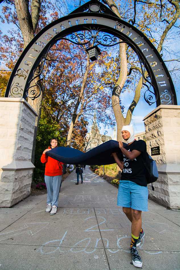 Weinberg freshmen Troy Thisler (front) and Aaron Clarke carry a mattress together as they walk past The Arch on Wednesday. Students participated in the demonstration of support for sexual assault survivors around Northwestern’s campus and on college campuses nationwide. 
