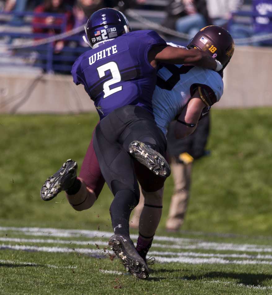 Dwight White makes a tackle in Northwestern’s game against Minnesota last year. The sophomore cornerback has decided to retire after learning he was born with only one kidney. 