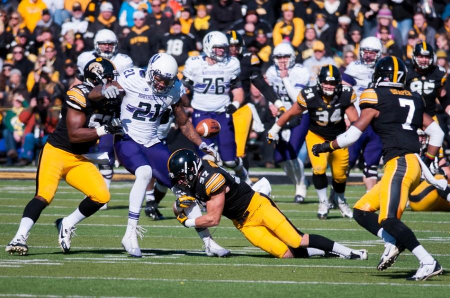 Kyle Prater fumbles the ball late in the first half. Prater’s bobble, which led to an Iowa touchdown, was one of a slew of Northwestern miscues en route to a 38-7 halftime deficit and a 48-7 defeat at the hands of the Hawkeyes.