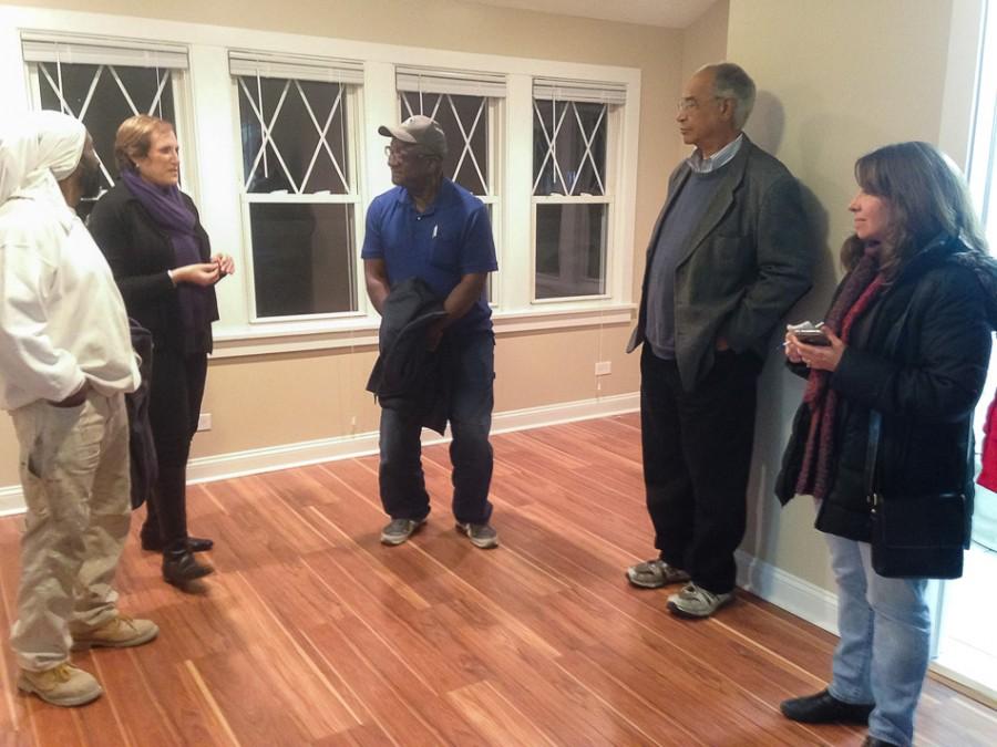 Community Partners for Affordable Housing staff, contractors, residents and city officials gather Wednesday for an open house at 1409 Darrow Ave. CPAH recently completed renovation on the house so it could be rented to a low- to moderate-income family.