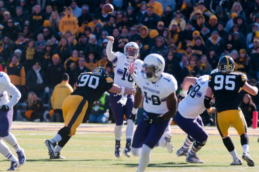Iowa defensive lineman Louis Trinca-Pasat hits junior quarterback Zack Oliver. Oliver struggled after replacing senior Trevor Siemian under center, going 1-of-6 for 7 yards in the fourth quarter of Northwestern’s 48-7 loss to Iowa on Saturday.