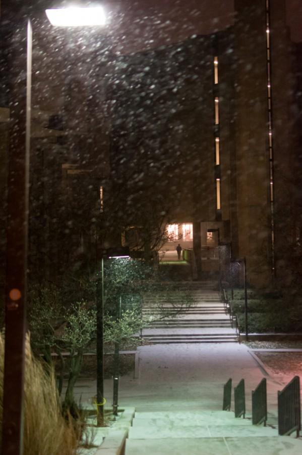 Snow falls outside of Norris University Center on Monday night. Ahead of the upcoming 2014-15 winter, Evanston started a campaign called Snow Awareness Week on Monday to secure community members’ preparedness for the snowfall.
