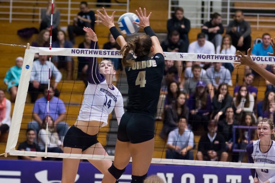 Senior Katie Dutchman battles a Purdue defender at the net in a recent match. Dutchman and the Wildcats lost their fourth straight match Wednesday, falling to Michigan State in four sets.