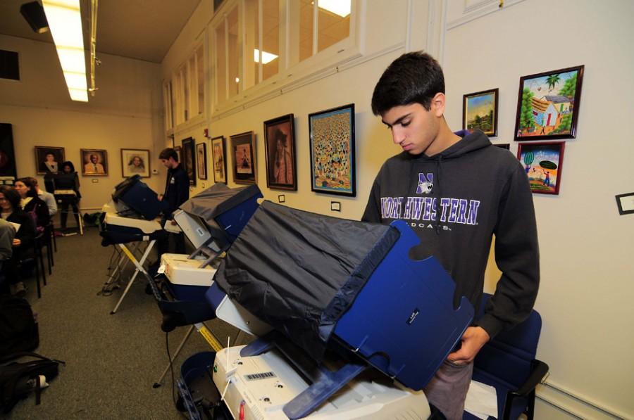 A Northwestern student casts his ballot at the Civic Center on Tuesday. Through NU services like the “Voter Van,” students were able to more easily get to polling places at Parkes Hall, Patten Gym and the Civic Center to vote.