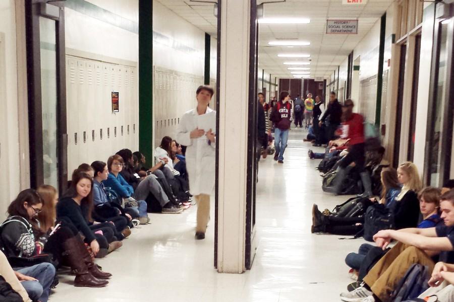 ETHS students participate in a demonstration Tuesday to protest grand jury decisions in the deaths of Eric Garner and Michael Brown. Students sat in the hallways for four and a half minutes during the demonstration.