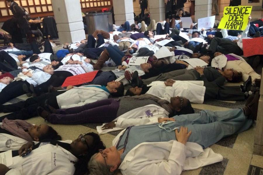 More than 100 students and faculty from Northwestern’s Feinberg School of Medicine participate in a 4.5-minute die-in. The protest was held in conjunction with a series of demonstrations at medical schools across the country on Wednesday.