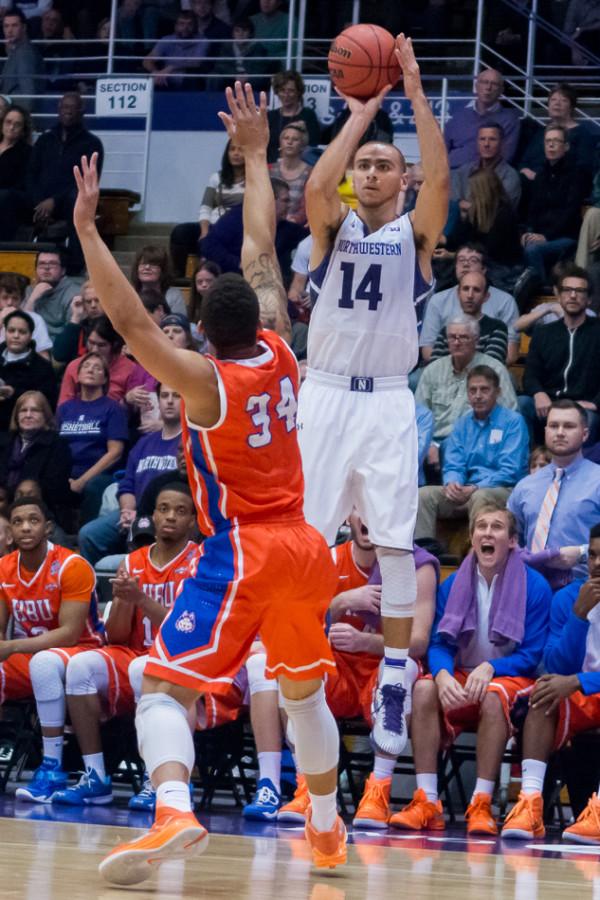 Tre Demps elevates for a shot over a defender. The junior guard leads Northwestern in scoring but is focused on his defensive game against Illinois.