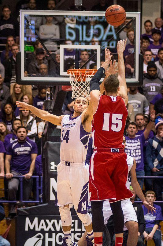 Wisconsins Sam Dekker shoots over junior guard Tre Demps. The Badger  forward was deadly from deep, nailing four of six from three-point land, part of a strong showing from the Badgers from beyond the arc. 