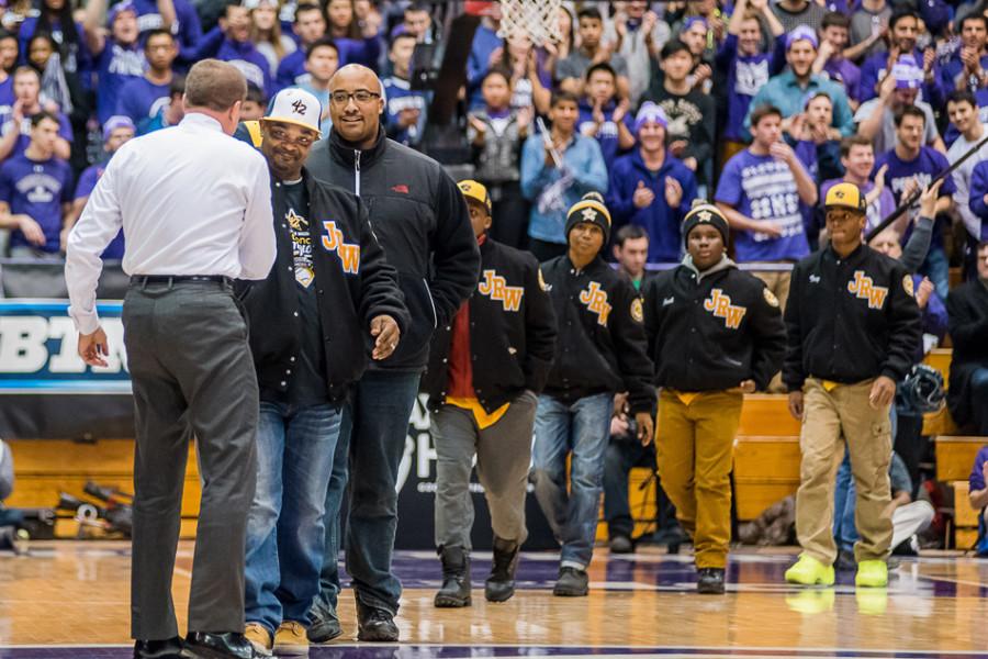The Jackie Robinson West baseball squad shakes hands with Northwestern athletic director Jim Phillips. The Chicago-based team was honored for its accomplishments at this summer’s Little League World Series on Wednesday night at Welsh-Ryan Arena, receiving a standing ovation from the crowd. 