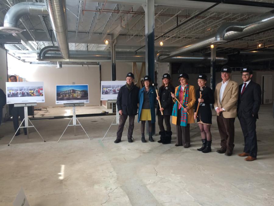 City officials, architects working on the new Evanston Art Center and center employees pose with sledgehammers and hardhats at the site’s groundbreaking Thursday. The new center, located on Central Street, is scheduled to be completed by early May.