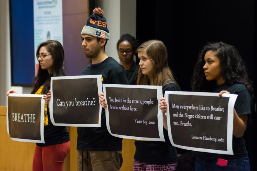 Students silently hold signs displaying quotes during a teach-in hosted by the Black People Making History Committee on Tuesday. The packed event featured discussions about the Black Lives Matter movement. 