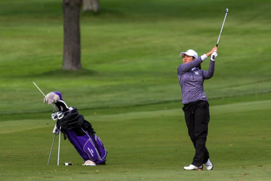 Suchaya Tangkamolprasert poses after an iron shot. The junior posted the lowest scoring average on the team in the fall but is just one of several talented NU golfers.