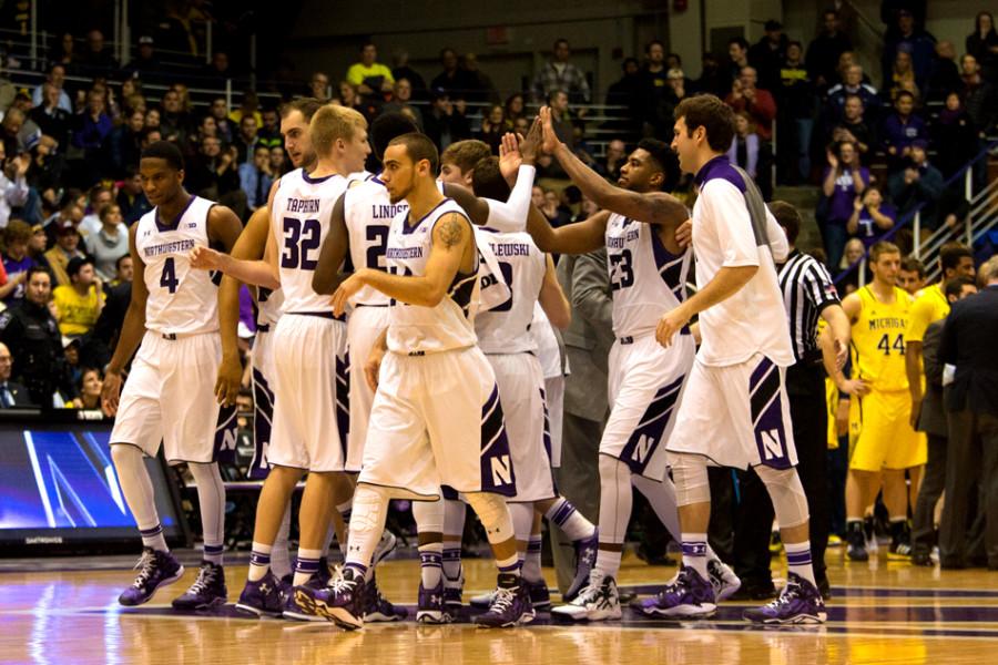 JerShon Cobb (23) celebrates with his teammates. The senior guard surprised his coach with 14 points and eight rebounds in the final game of his career at Welsh-Ryan Arena.
