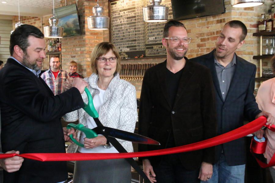 Mayor+Elizabeth+Tisdahl+and+members+from+Footman+Hospitality+cut+the+ribbon+at+Bangers+%26+Lace%E2%80%99s+grand+opening.+The+bar+officially+opened+in+the+space+formerly+occupied+by+The+Keg+of+Evanston+in+December+but+held+off+on+holding+a+ceremony+until+this+spring.+
