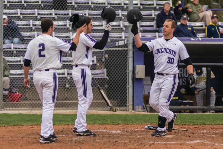 Joe+Hoscheit+celebrates+a+run+with+his+teammates.+The+sophomore%E2%80%99s+clutch+hitting+helped+Northwestern+rally+to+its+only+win+of+the+three-game+weekend.