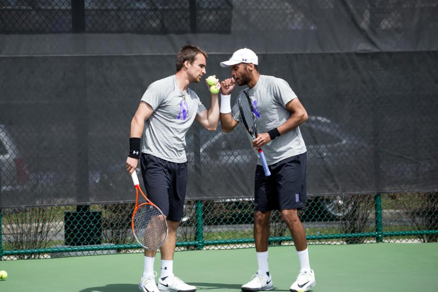Sophomore Sam Shropshire and senior Alex Pasareanu celebrate a point. The No. 44 doubles pair helped Northwestern to victory over Iowa on Sunday.