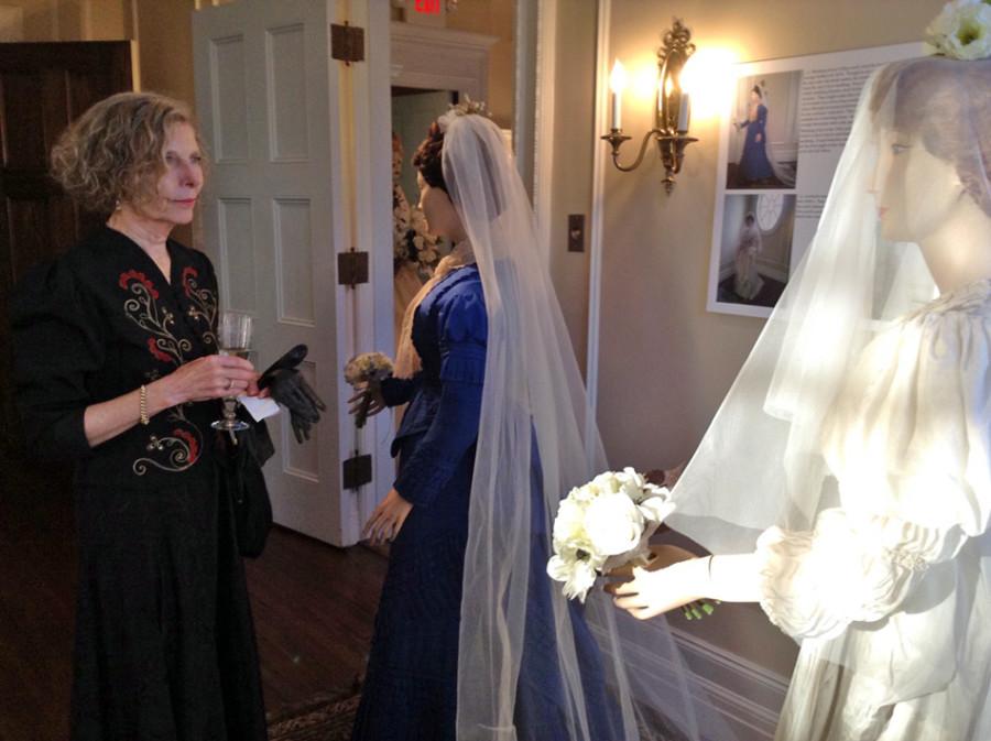 Evanston resident Susan Moss views a 19th-century wedding dress at the Evanston History Center’s new exhibit. The center held a wedding reception-themed opening event Thursday night for the exhibit. 