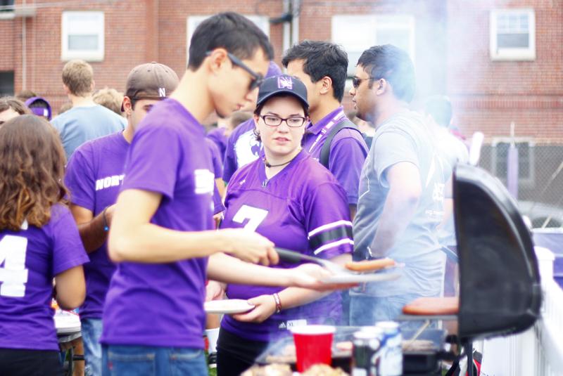 Students+grill+at+Fitzerland%2C+the+student-only+tailgate+section%2C+before+a+football+game.+Wildside%2C+NU+Athletics+and+University+administrators+amended+the+tailgate+area+to+draw+more+students.