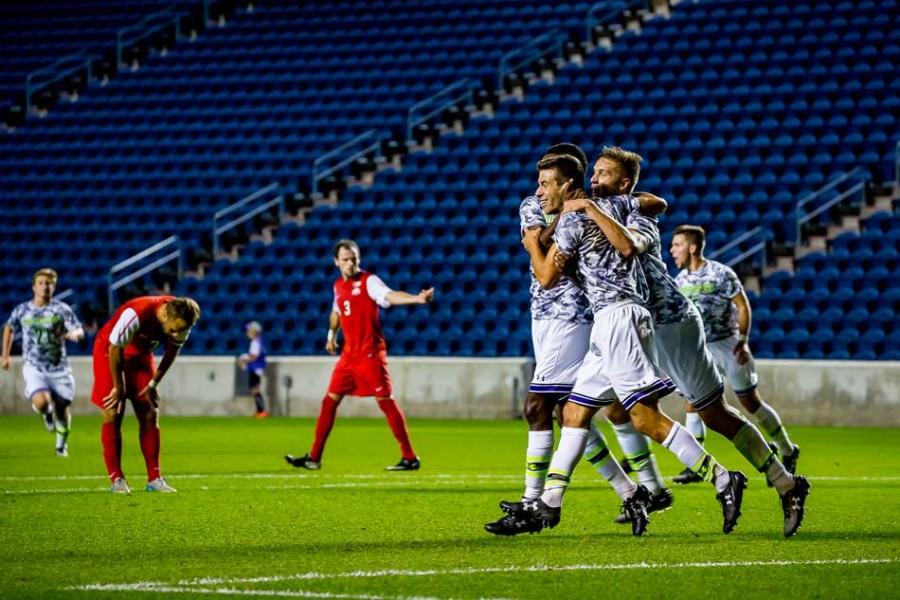 A pack of Wildcats celebrate a goal. Northwestern needed late game heroics from sophomore forwards Sam Forsgren and Elo Ozumba to escape UIC with a 2-1 double overtime victory on Wednesday.