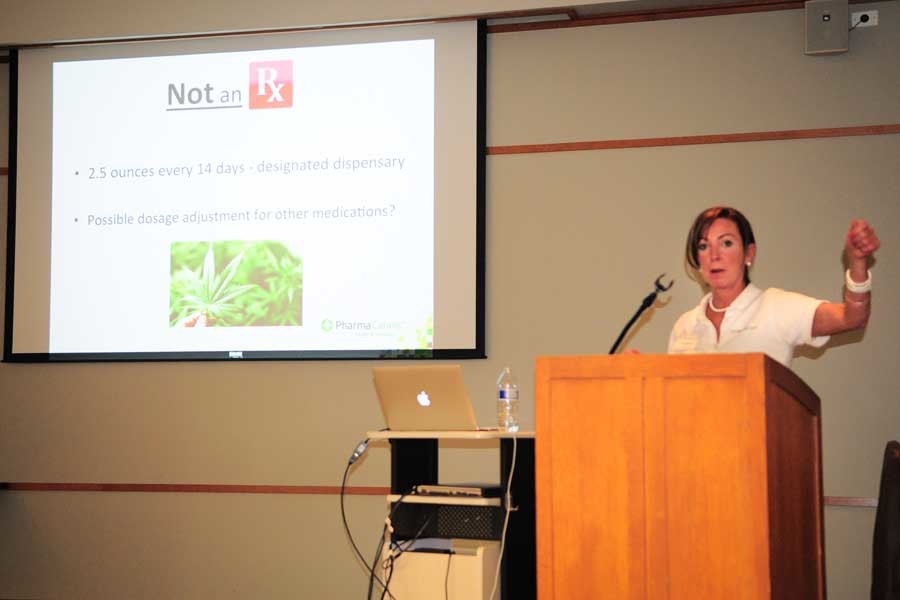 Patient development representative Liz Elliott speaks to Evanston residents about the benefits of medical marijuana as well as instructions on obtaining a medical card. Pharmacannis now plans to open its Evanston dispensary in mid-November.
