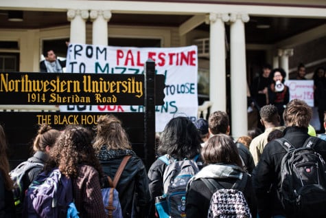 Students gather outside the Black House on Friday to protest institutional racism at Northwestern and other universities. The protesters later moved to Henry Crown Sports Pavilion, where they spoke out at a groundbreaking ceremony for a new athletic facility.
