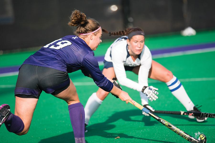 Freshman+midfielder+Puck+Pentenga+faces+off+with+a+defender.+Pentenga+and+the+Wildcats+outshot+Ohio+State+19+to+4+en+route+to+a+4-0+victory+in+their+Big+Ten+Tournament+quarterfinal+matchup+Thursday.