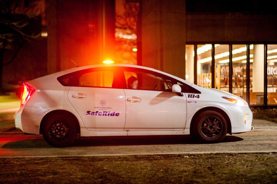 A Safe Ride car sits outside of University Library during the evening. The program designed to transport students safely during the night is still working out issues of high cancellation rates and low staffing this quarter.
