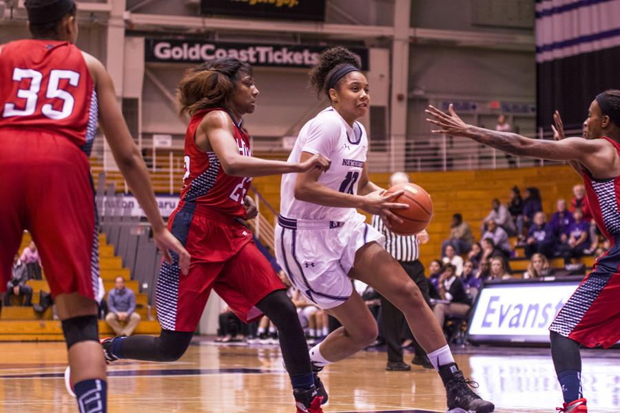 Nia Coffey drives past a defender as she attacks the rim. The junior forward controlled the glass for NU as she tied her career-high by grabbing 18 rebounds in the blowout victory.