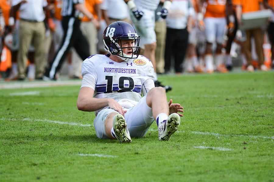 Redshirt freshman quarterback Clayton Thorson sits up after taking a hit Friday. Thorson struggled as Northwestern lost the Outback Bowl 45-6 to Tennessee.