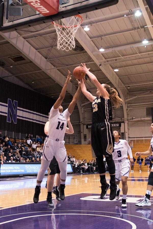 Pallas Kunaiyi-Akpanah fights for the rebound. The freshman forward committed two of Northwestern’s 21 turnovers in just 12 minutes on Thursday.