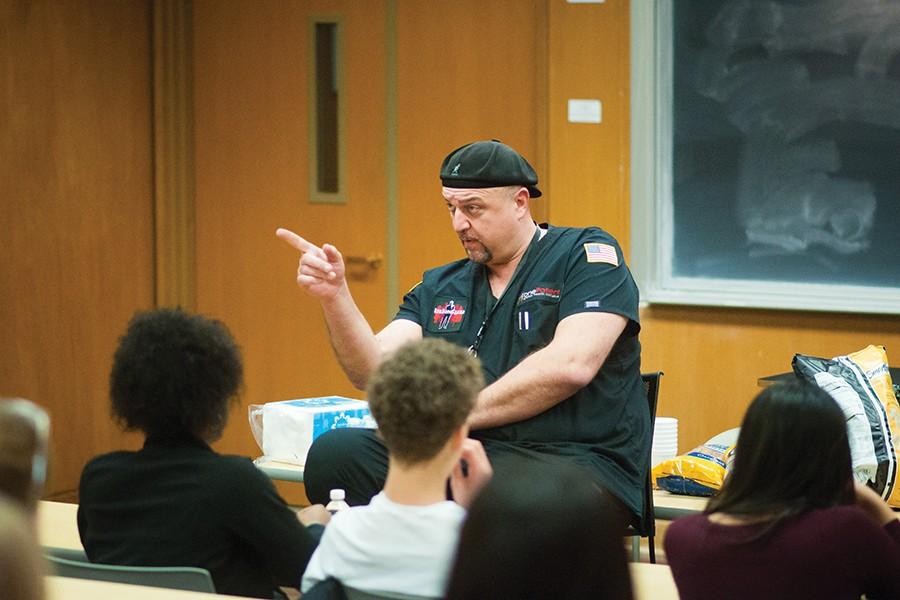 Humanitarian Daniel Ivankovich addresses a crowd of students from Northwestern and Whitney Young Magnet High School in the Technological Institute on Thursday. Ivankovich, the co-founder of nonprofit medical organization One Patient, encouraged students to make a difference in their communities.