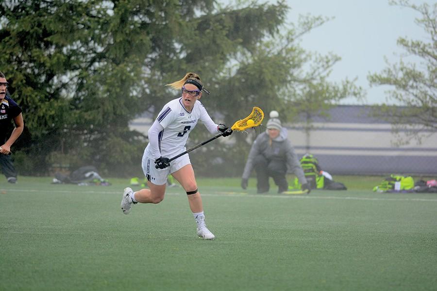 Christina Esposito cradles the ball in her stick. The junior has tallied three assists thus far in the 2016 season.