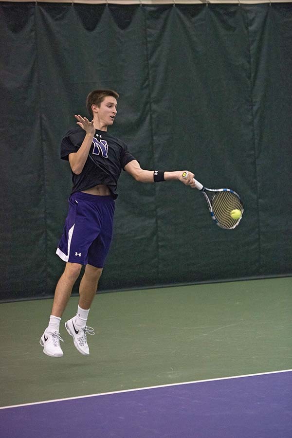 Ben Vandixhorn leaps on a forehand. The freshman has succeeded so far this season, solidifying the back end of Northwestern’s singles lineup.