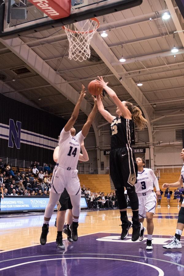 Pallas Kunaiyi-Akpanah leaps for the rebound. The freshman forwards 14 rebounds on Saturday marked the seventh time this season shes reached double-digit boards. 