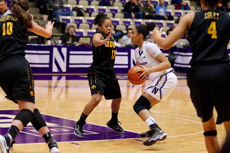 Nia Coffey dribbles around a defender. While the Cats have struggled, the junior forward has put up 20+ points in five of her last six games.