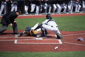 Jack Claeys tags a Michigan runner out at the plate. The sophomore catcher scored 2 of Northwestern’s 9 runs in Sunday’s loss. 