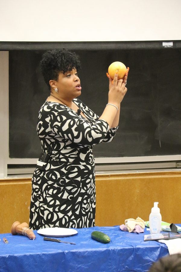 Auntie Angel, a Chicago-based sex educator, demonstrates a technique with a grapefruit. Angel spoke to roughly 200 students during an event at the Technological Institute on Friday.