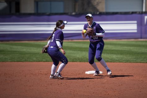 Andrea Filler (right) and Brooke Marquez regroup after fielding the ball. Filler leads the Wildcats in slugging percentage and is tied for first in home runs.