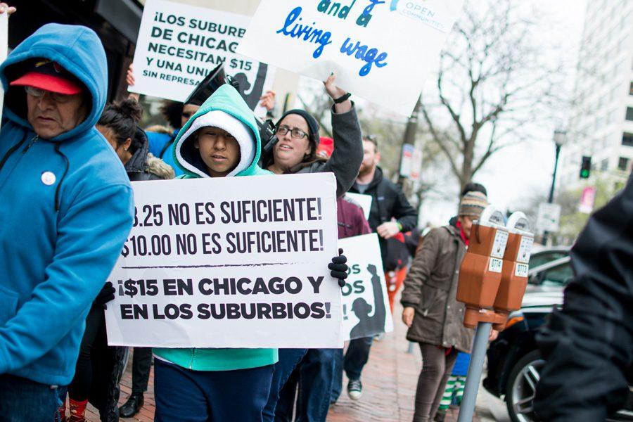 Workers, protesters and activists march to the Burger King on Orrington Avenue on Sunday afternoon to protest low wages in Evanston. The marchers later demonstrated outside McDonald’s on Dempster Street, demanding better working conditions. 