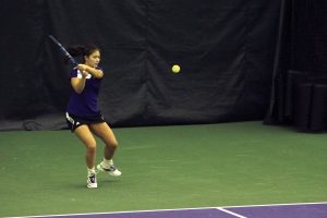 Nida Hamilton hits a backhand during her time as a student-athlete. Hamilton last played for the Wildcats in 2014 and is now a volunteer assistant coach.