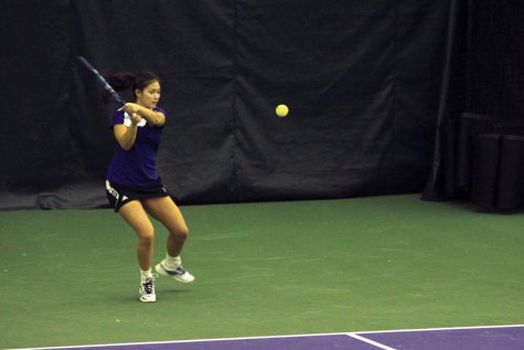 Nida Hamilton hits a backhand during her time as a student-athlete. Hamilton last played for the Wildcats in 2014 and is now a volunteer assistant coach.